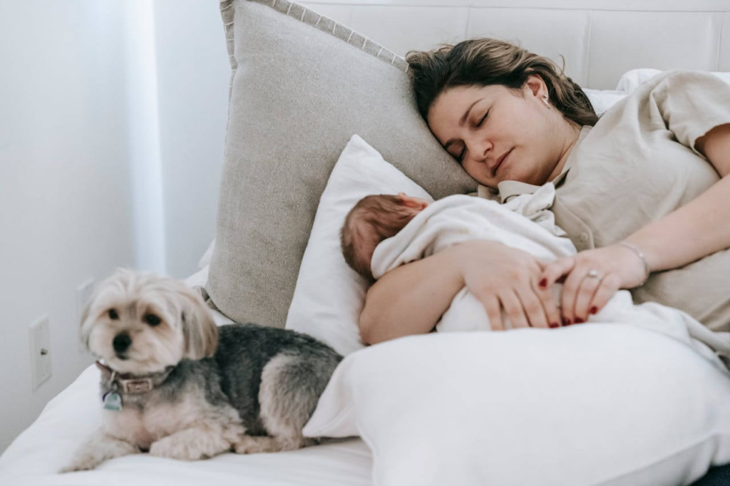 Mother trying to relax while baby is sleeping, but feeling tensed and unable to sleep