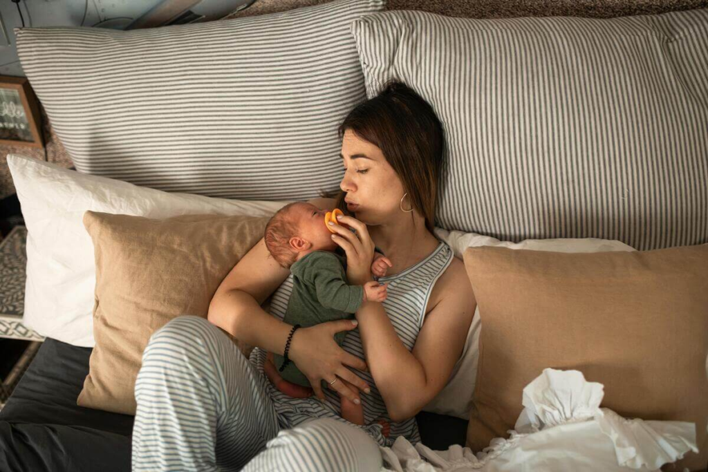 First-time mom with postpartum anxiety holding her baby at night