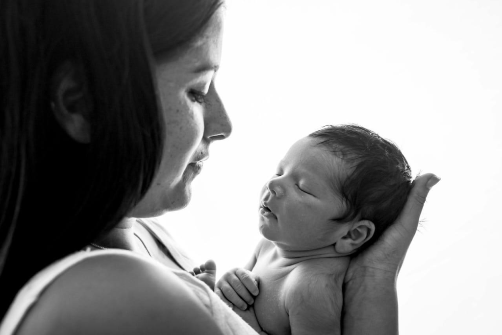 Mother looking worried something bad will happen to her baby while her baby sleeps
