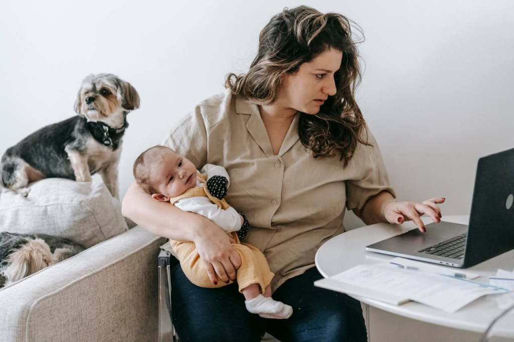 Tired new mother googling baby's symptoms because she is experiencing constant fear and she can't switch off